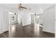 Spacious living area featuring sleek flooring, ceiling fans, fresh paint, and an open layout at 102 21St Ne St, Bradenton, FL 34208