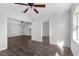 Spacious living room featuring wood-look floors, neutral walls, and ceiling fan at 102 21St Ne St, Bradenton, FL 34208