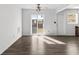 Bright living room featuring sliding glass doors, a ceiling fan, and wood-look flooring at 102 21St Ne St, Bradenton, FL 34208