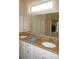 Bathroom vanity features double sinks and granite countertops for a touch of luxury at 1182 Yorkshire St, Port Charlotte, FL 33952