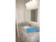 Bathroom vanity with marble counter top, sink, towel and modern hardware plus an ornate mirror at 1182 Yorkshire St, Port Charlotte, FL 33952
