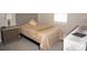 Cozy bedroom features a comfortable bed with a tufted headboard and neutral decor, creating a serene retreat at 1182 Yorkshire St, Port Charlotte, FL 33952