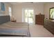 Bedroom featuring natural light, complemented by wood dresser and serene backyard view at 1182 Yorkshire St, Port Charlotte, FL 33952