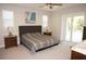 Spacious bedroom with decorative headboard, ceiling fan, and abundant natural light at 1182 Yorkshire St, Port Charlotte, FL 33952