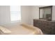 Inviting bedroom featuring a dresser and neutral bedding, offering a comfortable and serene ambiance at 1182 Yorkshire St, Port Charlotte, FL 33952