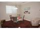 Cozy dining area with a round table, floral tablecloth, and natural light from the window at 1182 Yorkshire St, Port Charlotte, FL 33952