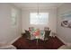 Bright dining area features round table with a floral tablecloth and neutral decor at 1182 Yorkshire St, Port Charlotte, FL 33952