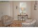 Inviting entryway showcasing charming chairs, console table, and natural light at 1182 Yorkshire St, Port Charlotte, FL 33952