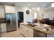 Spacious kitchen with stainless steel refrigerator, granite island, and open layout at 1182 Yorkshire St, Port Charlotte, FL 33952