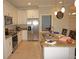 Modern kitchen with granite countertops, stainless steel appliances, and white cabinetry at 1182 Yorkshire St, Port Charlotte, FL 33952