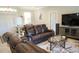 Spacious living room featuring comfortable leather seating, stylish decor, and abundant natural light at 1182 Yorkshire St, Port Charlotte, FL 33952