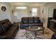 Inviting living room with plush leather sofas, decorative rug, and a bright atmosphere at 1182 Yorkshire St, Port Charlotte, FL 33952