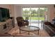 Open concept living area with sliding glass doors to a patio and serene water view at 1182 Yorkshire St, Port Charlotte, FL 33952