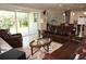 Cozy living room with plush leather furniture and a sliding glass door to the outdoors at 1182 Yorkshire St, Port Charlotte, FL 33952