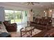 Spacious living room featuring comfortable leather seating and a sliding glass doors providing natural light at 1182 Yorkshire St, Port Charlotte, FL 33952
