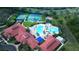 Stunning aerial view of community amenities with pool, tennis courts, and clubhouse at 1393 Kelp Ct, North Port, FL 34289