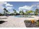 Resort-style community pool surrounded by palm trees and ample lounging space at 1393 Kelp Ct, North Port, FL 34289