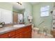 Well-lit bathroom featuring a vanity with a mirror, shower, and accessibility features for convenience at 145 Brig E Cir, Placida, FL 33946
