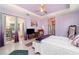 Light-filled bedroom with access to a screened lanai, offering a tranquil retreat for relaxation at 145 Brig E Cir, Placida, FL 33946