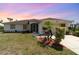 Charming single-story home with well-manicured lawn, landscaped flower beds, and inviting entrance at 145 Brig E Cir, Placida, FL 33946