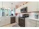 Close-up view of the stylish kitchen featuring quartz countertops, stainless steel appliances, and ample cabinet space at 145 Brig E Cir, Placida, FL 33946