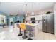 Bright, modern kitchen with stainless steel appliances, pendant lighting, and a breakfast bar with seating at 145 Brig E Cir, Placida, FL 33946