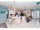 Open kitchen with modern appliances, breakfast bar, and seamless access to the dining and living areas at 145 Brig E Cir, Placida, FL 33946