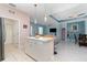 Well-lit kitchen showing views of the connecting dining room and living room providing an open layout at 145 Brig E Cir, Placida, FL 33946