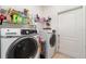 Functional laundry room with modern front-loading washer and dryer, storage shelves, and a utility sink at 145 Brig E Cir, Placida, FL 33946