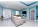 Bright, open living room features modern furniture, a ceiling fan, and seamless floors at 145 Brig E Cir, Placida, FL 33946