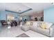 Open concept living area featuring hard surface floors, a tray ceiling, and seamless flow to the kitchen at 145 Brig E Cir, Placida, FL 33946