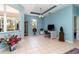 Bright, cheerful home office space with large windows and neutral tile flooring, ready for a workspace at 145 Brig E Cir, Placida, FL 33946