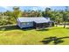 Beautiful exterior view of a home with a metal roof and screened porch at 14760 Conway Rd, Port Charlotte, FL 33981