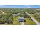 Aerial view of a home in a community surrounded by lush greenery at 15172 Mcgraw Ave, Port Charlotte, FL 33953