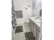 Bathroom with gray vanity and patterned shower curtain at 15172 Mcgraw Ave, Port Charlotte, FL 33953