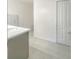 Bright bathroom featuring a single sink, white countertop, and gray tiled floor at 15172 Mcgraw Ave, Port Charlotte, FL 33953