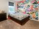 Bedroom with gray carpet, a graphic wall, and window with blinds at 15172 Mcgraw Ave, Port Charlotte, FL 33953