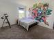 Bedroom with colorful graphic wall, large window with gray blinds, and gray carpet at 15172 Mcgraw Ave, Port Charlotte, FL 33953