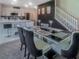 Elegant dining room with unique centerpieces and staircase, adjacent to the kitchen with barstool seating at 15172 Mcgraw Ave, Port Charlotte, FL 33953