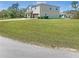 Two-story home featuring a well-maintained lawn and a spacious driveway at 15172 Mcgraw Ave, Port Charlotte, FL 33953