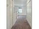 Hallway with carpet, white walls, and multiple closet doors at 15172 Mcgraw Ave, Port Charlotte, FL 33953