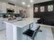 Modern kitchen island with marble countertops, stainless steel appliances, and sleek barstool seating at 15172 Mcgraw Ave, Port Charlotte, FL 33953