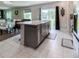 Bright and open kitchen with an island, stainless steel appliances, and a dining area nearby at 15172 Mcgraw Ave, Port Charlotte, FL 33953
