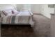 Cozy bedroom with a bed, crib, and ample space, illuminated by natural light from a window at 15172 Mcgraw Ave, Port Charlotte, FL 33953