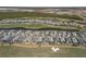A high angle shows the arrangement of homes in a row across a manicured golf course setting at 15931 Sugar Hill Dr, Punta Gorda, FL 33982