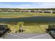 A sunny backyard view overlooks a small lake and a golf course beyond at 15931 Sugar Hill Dr, Punta Gorda, FL 33982
