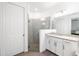 Stylish bathroom with granite countertops, a glass-enclosed shower, and wood-look floors at 15931 Sugar Hill Dr, Punta Gorda, FL 33982