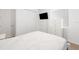 Bright bedroom features wood-look flooring, tv, closet and a sunny window at 15931 Sugar Hill Dr, Punta Gorda, FL 33982