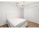 Bright bedroom features wood-look flooring, closet and ceiling fan at 15931 Sugar Hill Dr, Punta Gorda, FL 33982