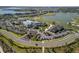 A wide shot shows a community center and parking situated near a body of water at 15931 Sugar Hill Dr, Punta Gorda, FL 33982